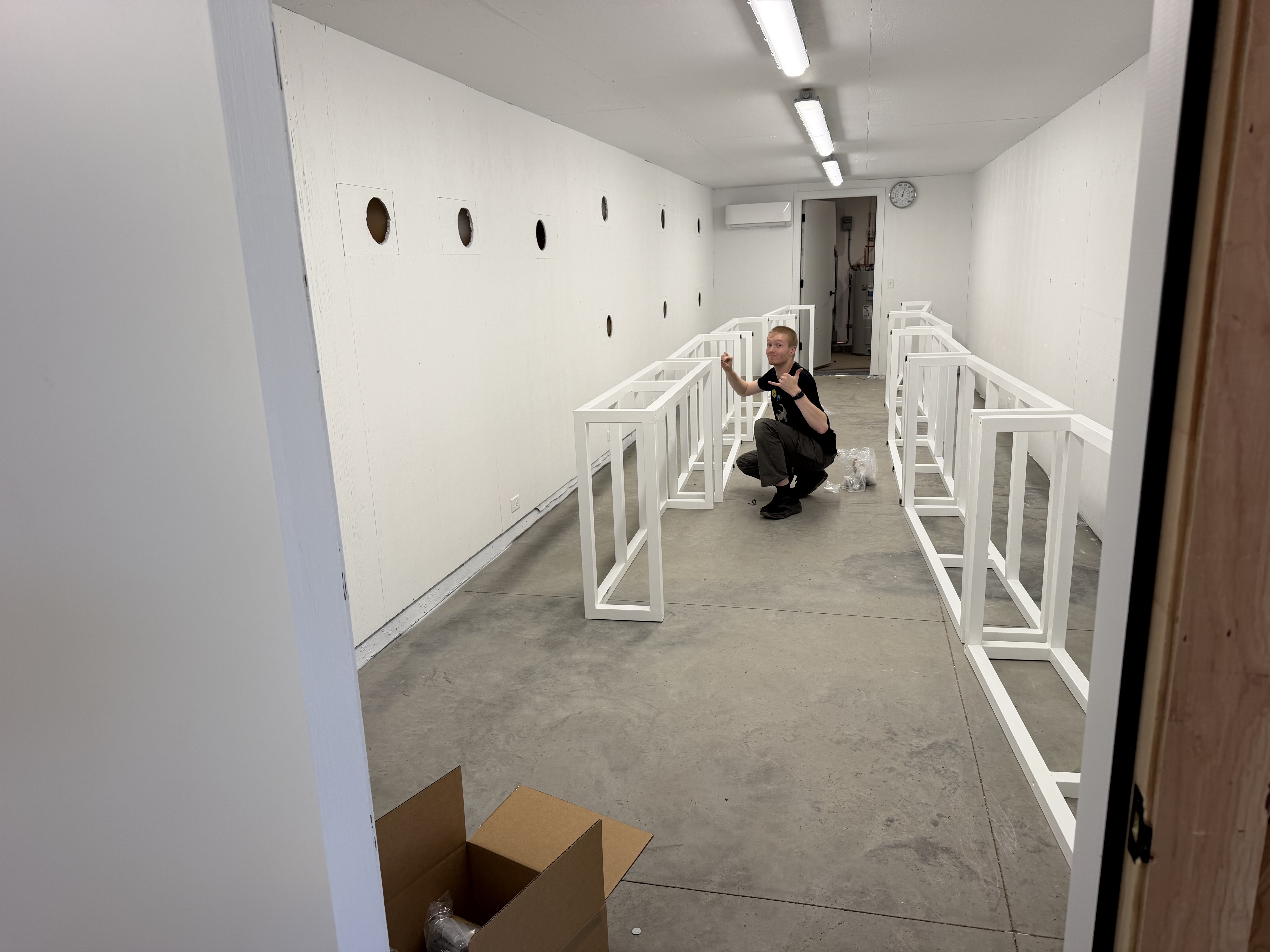 Cold room under construction with rows of white enclosure stands